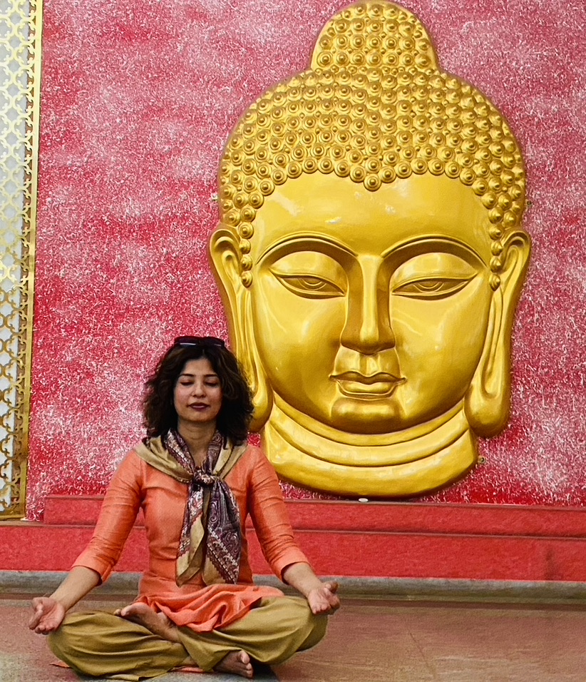 Meditation in front of a golden Buddha